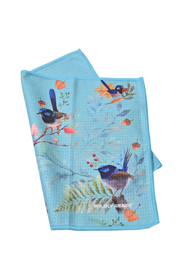 Blue towel with bird and nature design on a white background